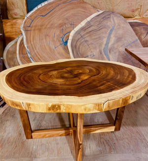 Round live edge dining or conference table made from solid Guanacaste wood with wooden base. 